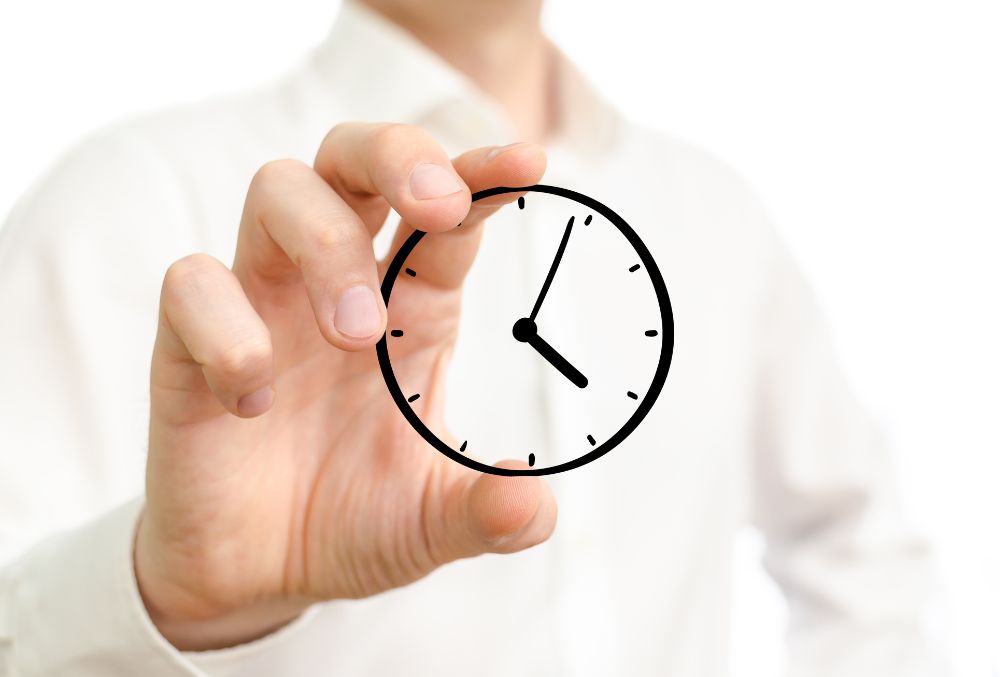 A hand holding an imaginary clock figure.