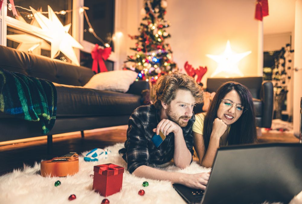 A woman and a man looking at a computer screen during holiday season.